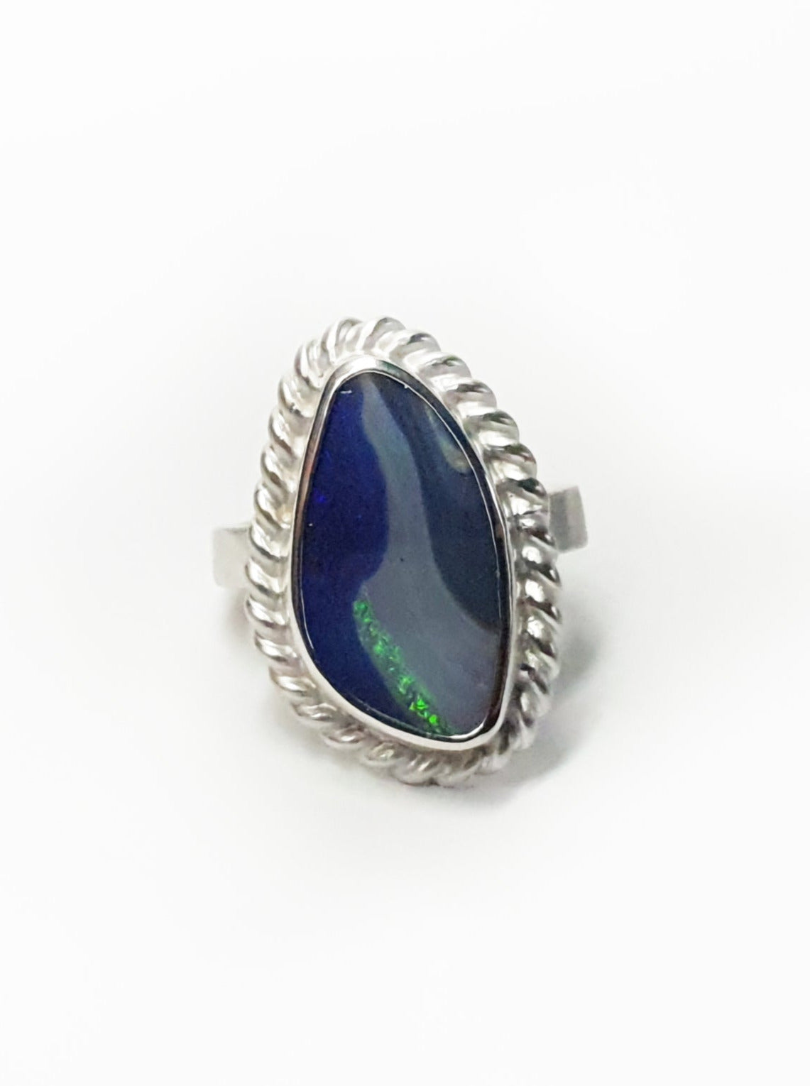 Silver ring with twist frame and wide hammered band. Blue queensland boulder opal and flashes of aqua. Australian made and hand crafted for a unique style. Ethical jewellery using ethical and local queensland materials.