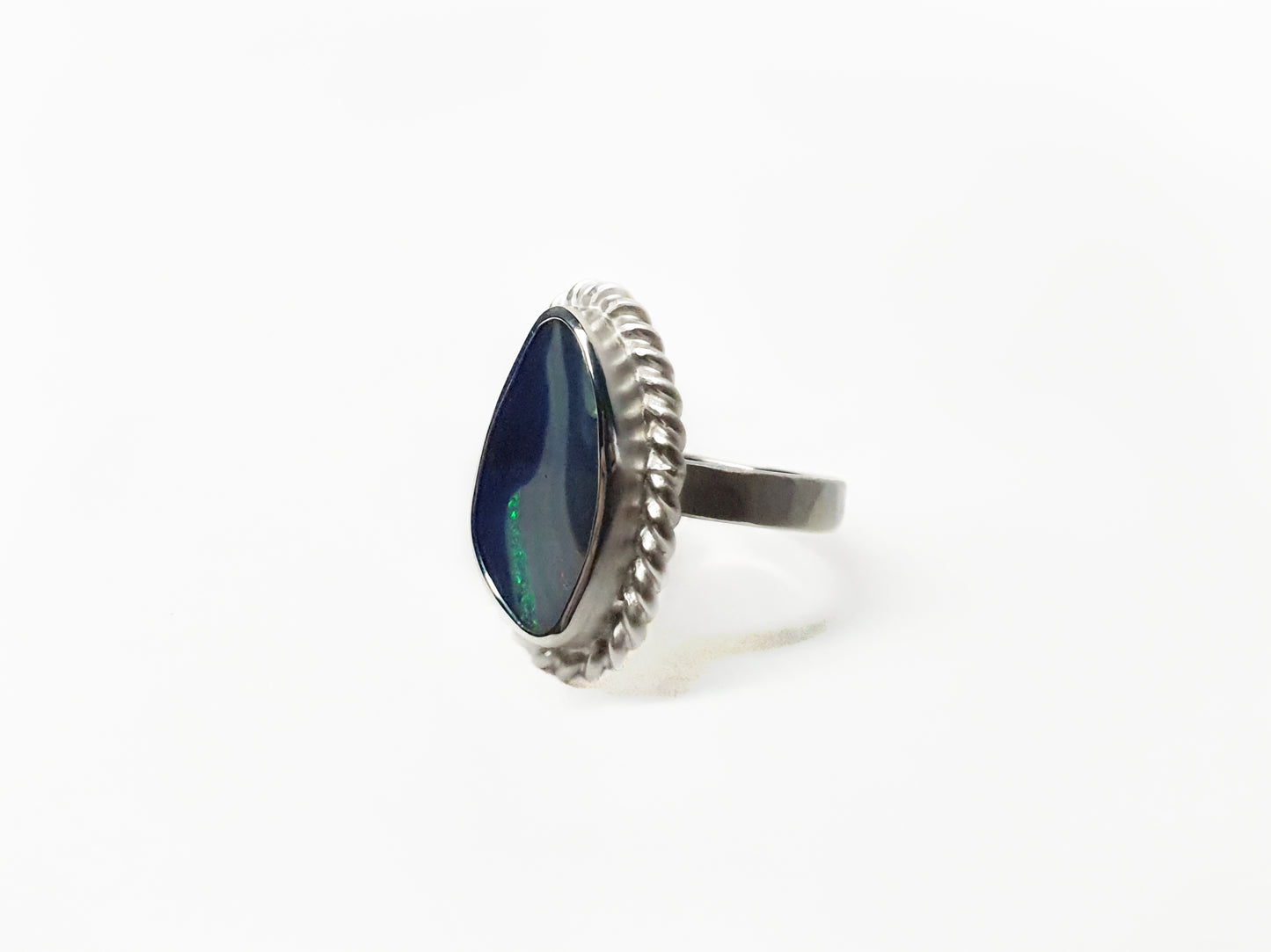 Silver ring with twist frame and wide hammered band. Blue queensland boulder opal and flashes of aqua. Australian made and hand crafted for a unique style. Ethical jewellery using ethical and local queensland materials.