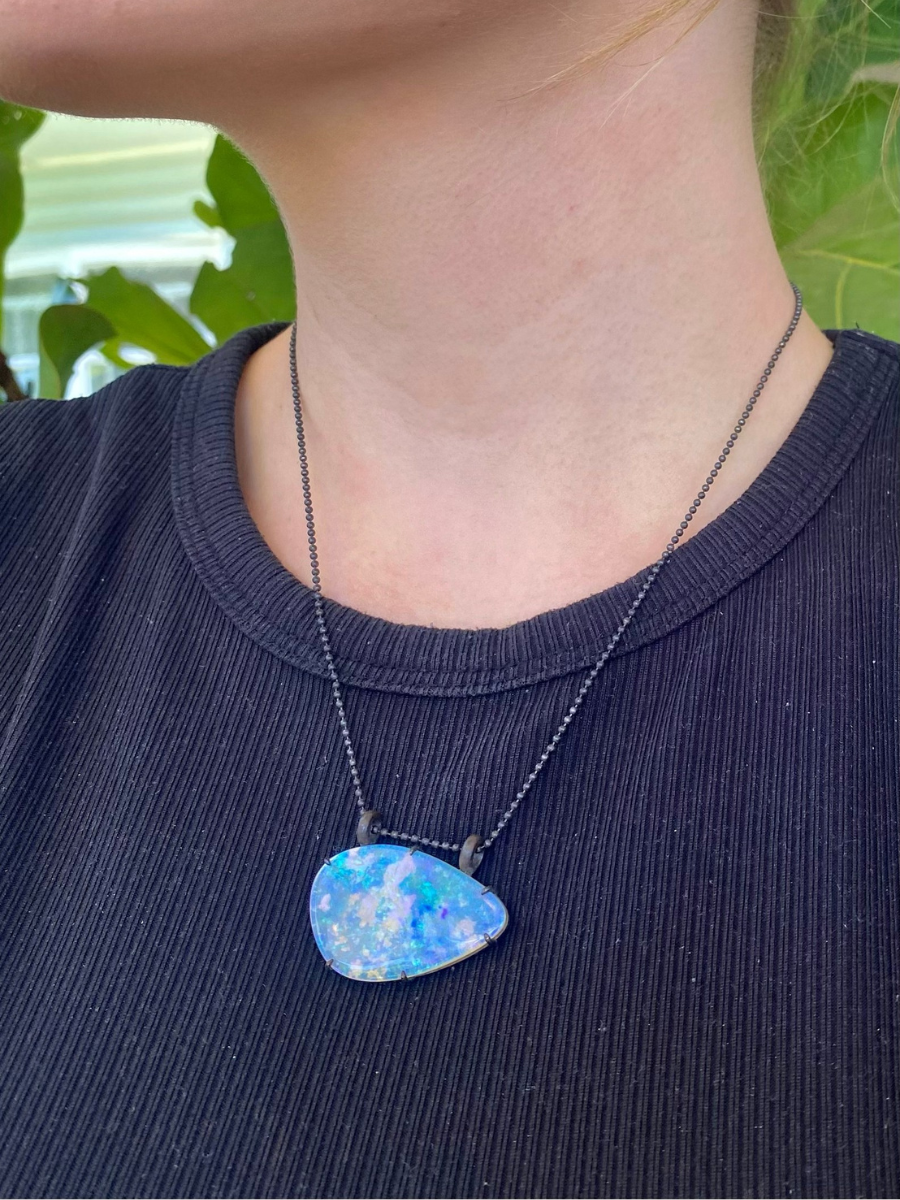 wearing purple lightning ridge boulder opal pendant with blackened silver Glasshouse Mountains