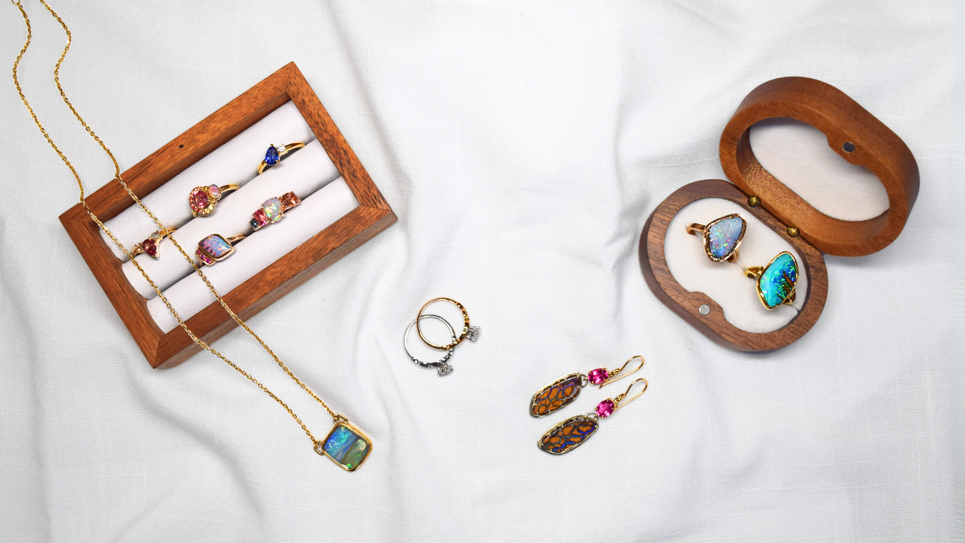 handmade, custom jewellery, including earrings, rings, pendants with Australian, natural gemstones, set on a white background.
