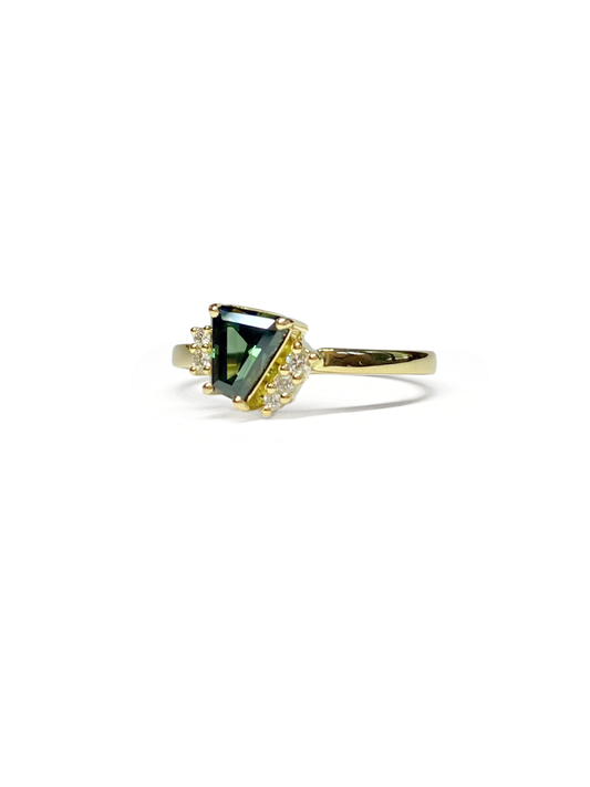 Silver earring with a clear teal sapphire and accent diamonds on a white background