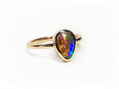 9ct Yellow Gold teardrop boulder opal ring. Polished ring with a blue, red, green and orange opal. Australian Made and handcrafted in our brisbane studio using ethically sourced materials.