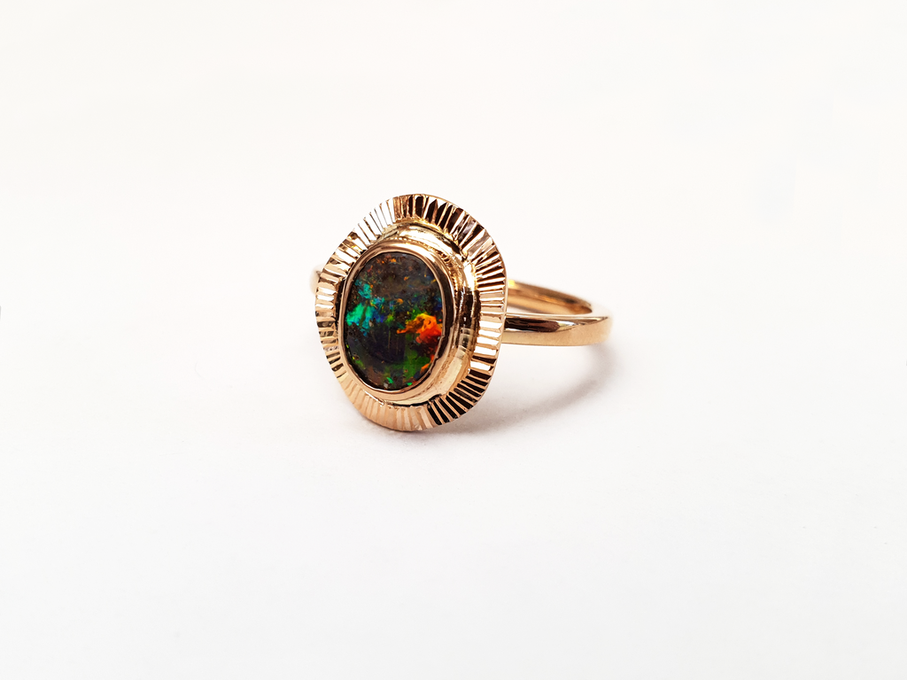 Green, Blue and Red Queensland Boulder Opal set in 9ct Rose Gold ring. Rose gold fans out around the stunning opal creating a unique and high quality ring. Australian made, and hand crafted for a unique style. Our products are all made with ethically sourced materials and handcrafted in our Brisbane studio