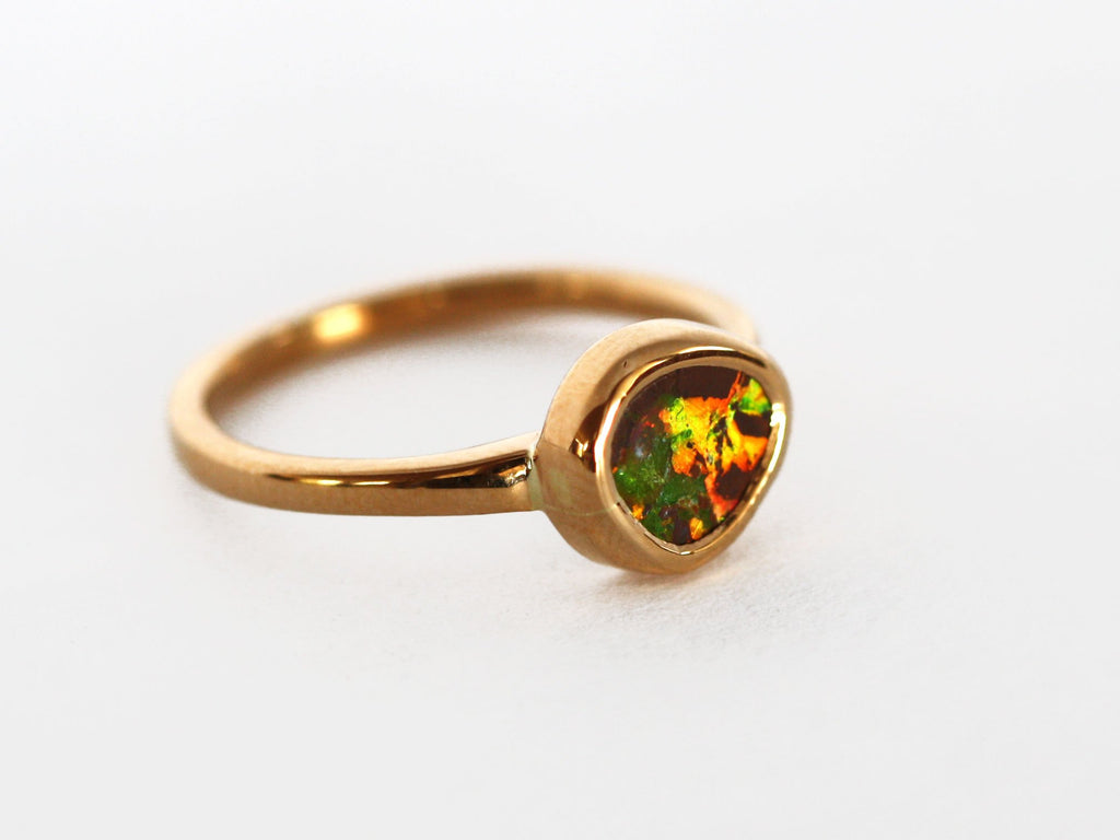 22ct gold Queensland Boulder Opal ring. This opal is multi coloured with greens and reds being most prominent. When in certain light the opal has a red horse shape shine through the green. This is a high quality ring hand crafted and Australian made by Custom Jewellery Co. This ring was hand crafted using ethical and local materials in our coastal Queensland studio