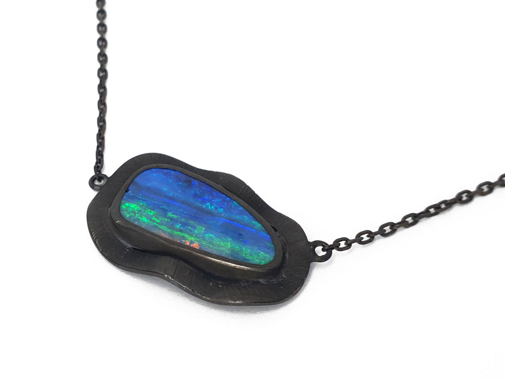 This amazing solid Queensland Boulder Opal has be paired with a dramatic blackened silver fringe. All of our products are from ethically sourced materials, and have been hand crafted in our Coastal Queensland studio