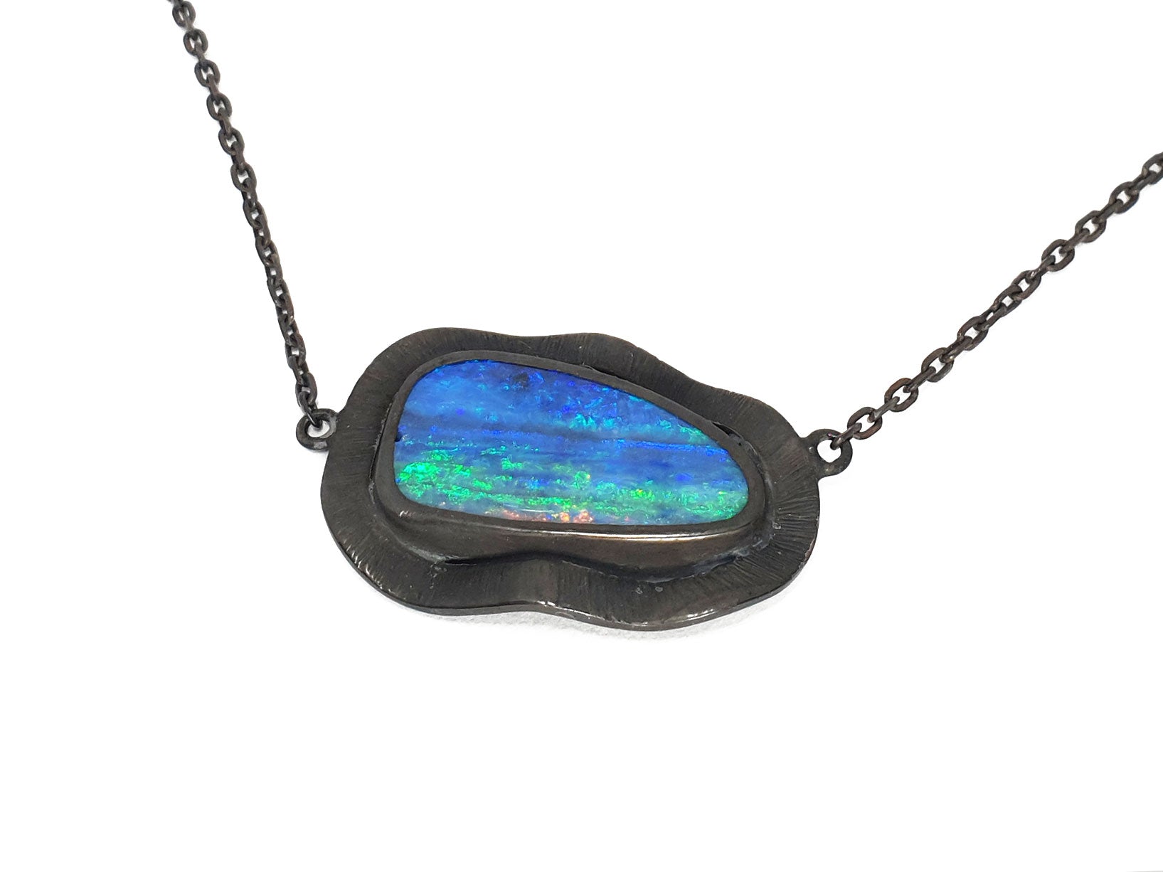 This amazing solid Queensland Boulder Opal has be paired with a dramatic blackened silver fringe. All of our products are from ethically sourced materials, and have been hand crafted in our Coastal Queensland studio