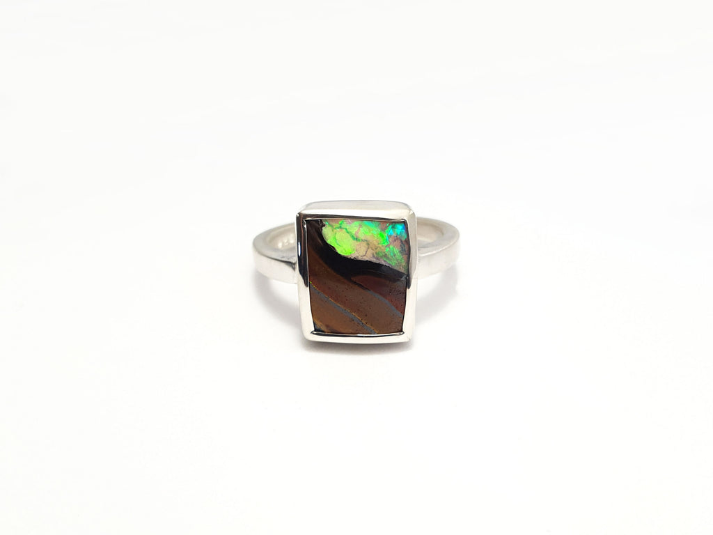Square Queensland boulder opal set in silver. You can see the stone through the opal. Locally sourced and ethically sourced materials. Handcrafted, Australian designed, Australian made for a high fashion product