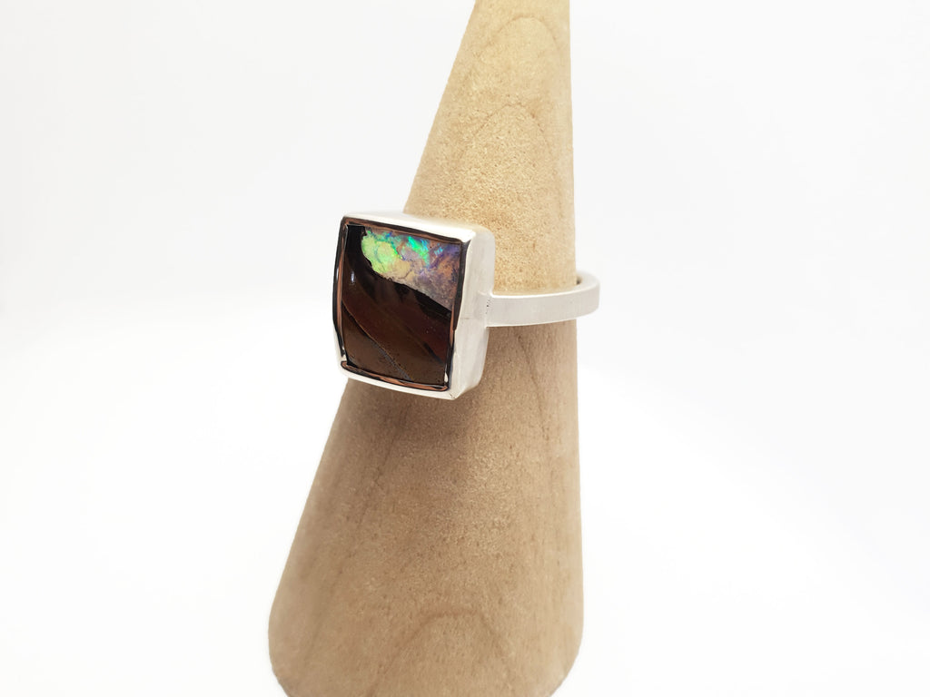 Square Queensland boulder opal set in silver. You can see the stone through the opal. Locally sourced and ethically sourced materials. Handcrafted, Australian designed, Australian made for a high fashion product