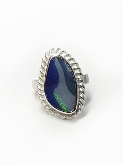 Silver ring with twist frame and wide hammered band. Blue queensland boulder opal and flashes of aqua. Australian made and hand crafted for a unique style. Ethical jewellery using ethical and local queensland materials. 