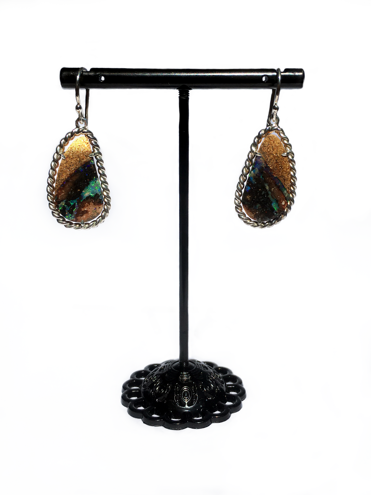 Queensland boulder opal drop earrings with a silver twist frame. Handcrafted, Australian made ethical jewellery with locally sourced Queensland products. Queensland boulder opal with stone, greens and blues. 