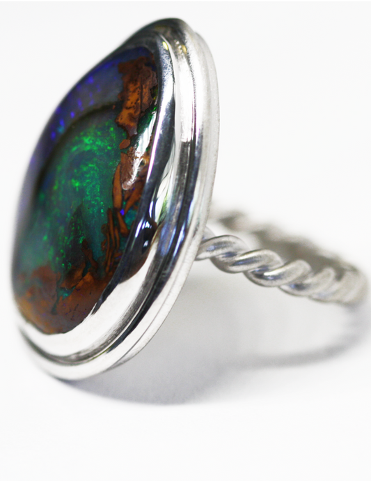 Queensland Boulder opal set in silver bezel with twisted band. Large green and red opal. Hand crafted in Brisbane studio using ethically sourced materials. Australian made sparkling opal ring. 