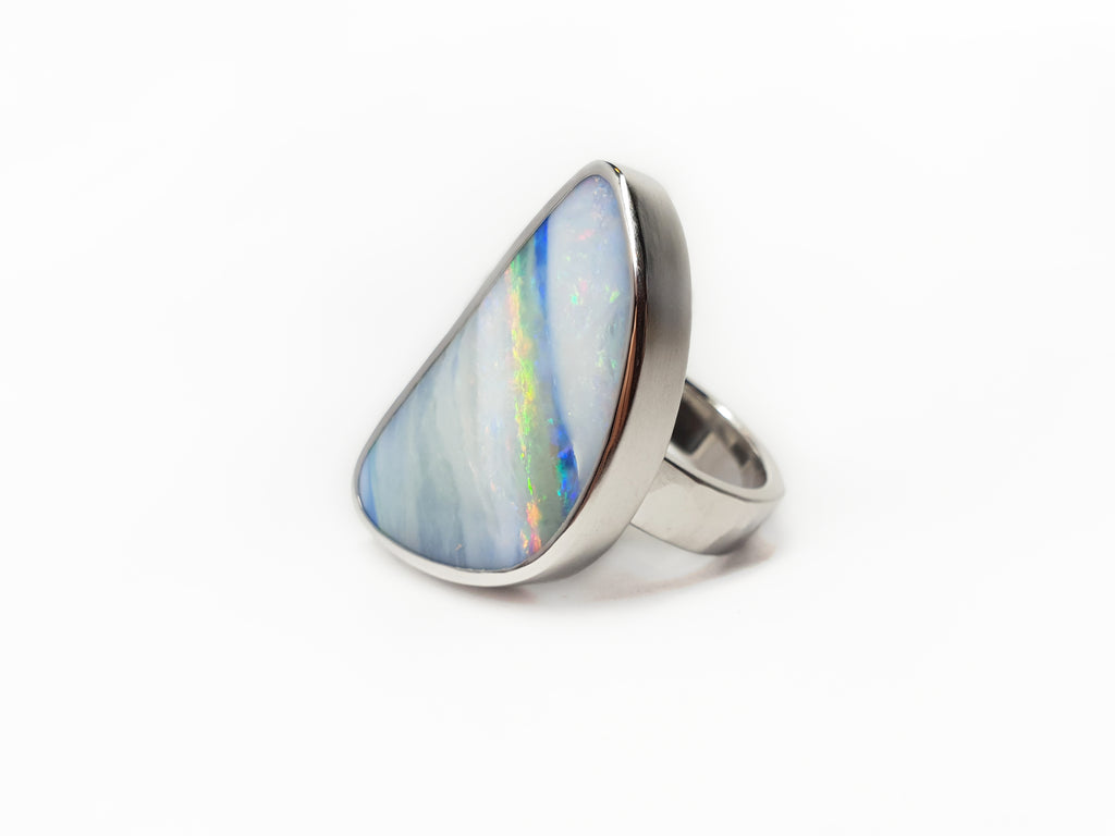 Solid Silver Queensland Boulder Opal ring. Australian made and handcrafted in our brisbane studio, this bright ring has streaks of blues and pinks throughout, resembling a rainbow. 