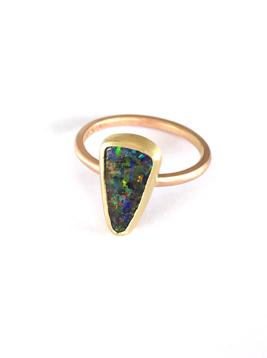Rose gold and qld boulder opal, with blues greens and reds flashing through. This is an Australian made and designed, handcrafted ring using local Queensland materials. Ethical jewellery using ethically sourced materials.