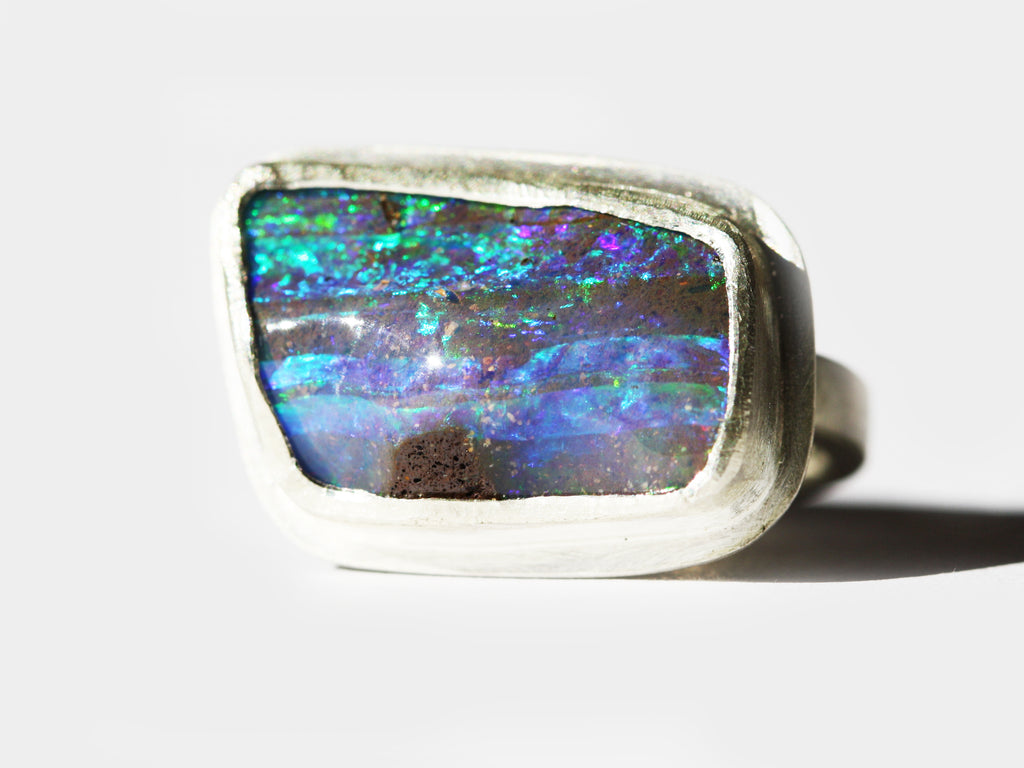 Australian made and handcrafted in our Brisbane, ethical jewellery made from local products. Silver ring with a textured setting and a blue and green qld boulder opal.